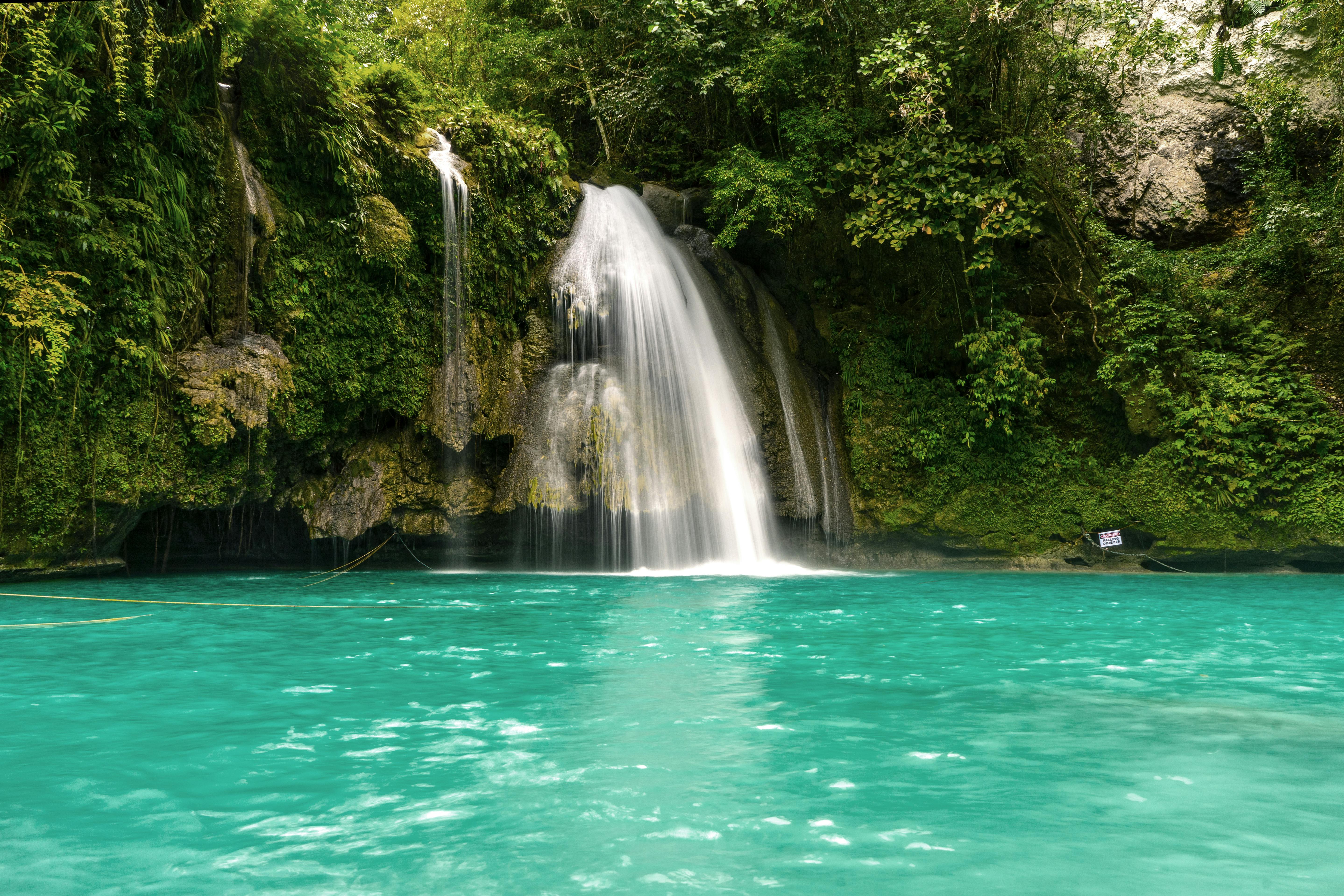 A small waterfall flowing into a turquoise lake